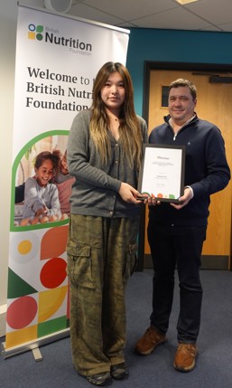 A photo of a teacher receiving her award at the Education Conference